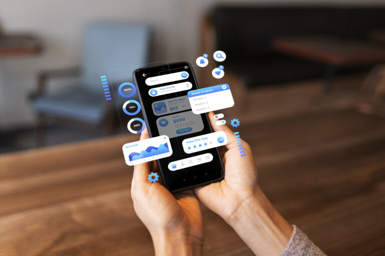Hands holding a smartphone displaying various floating digital elements and chat bubbles, symbolizing interactive app development and user experience, which is key for a Flutter app development company